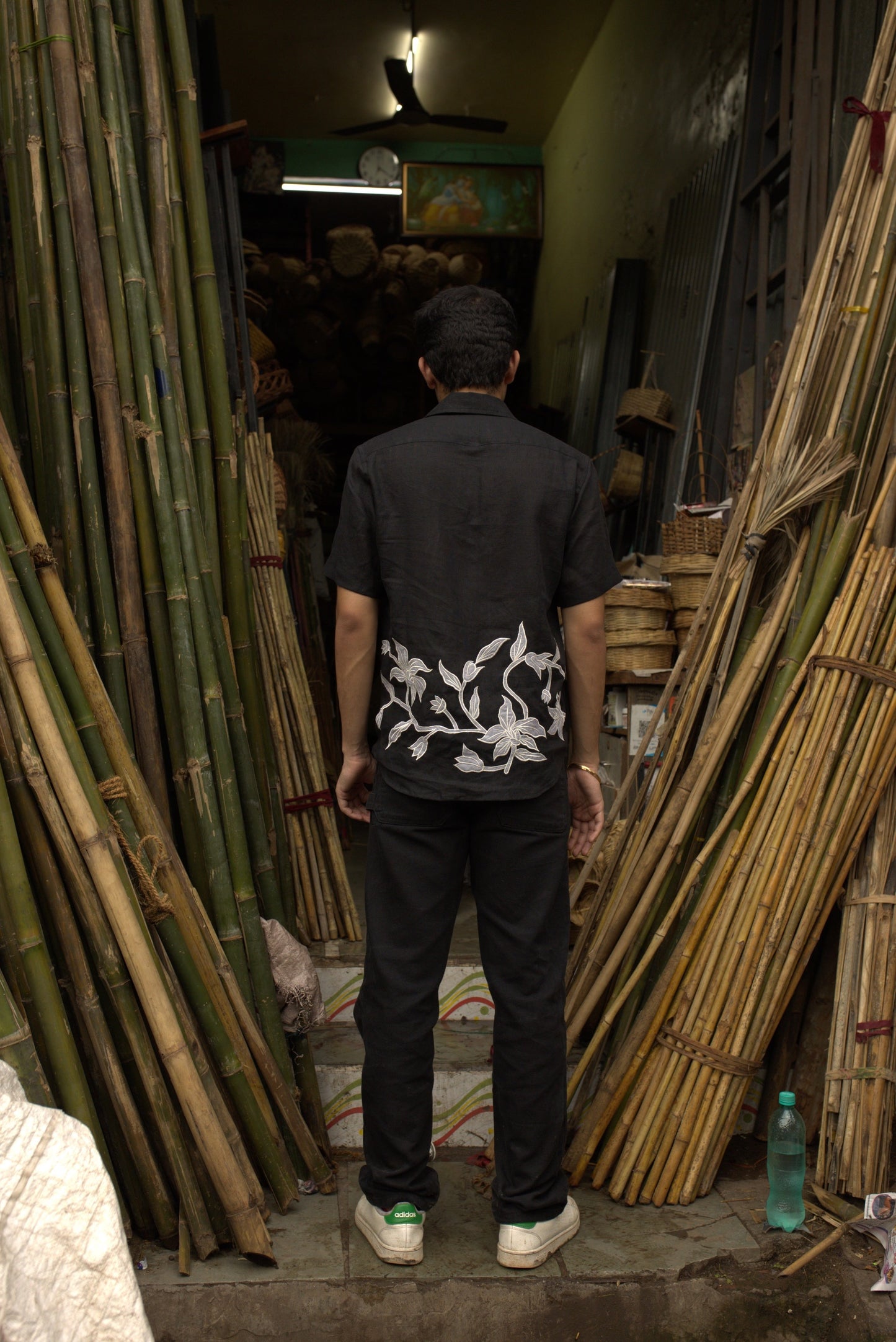 back detail of a black linen shirt with silk lilies cut and stitched with the patchwork technique