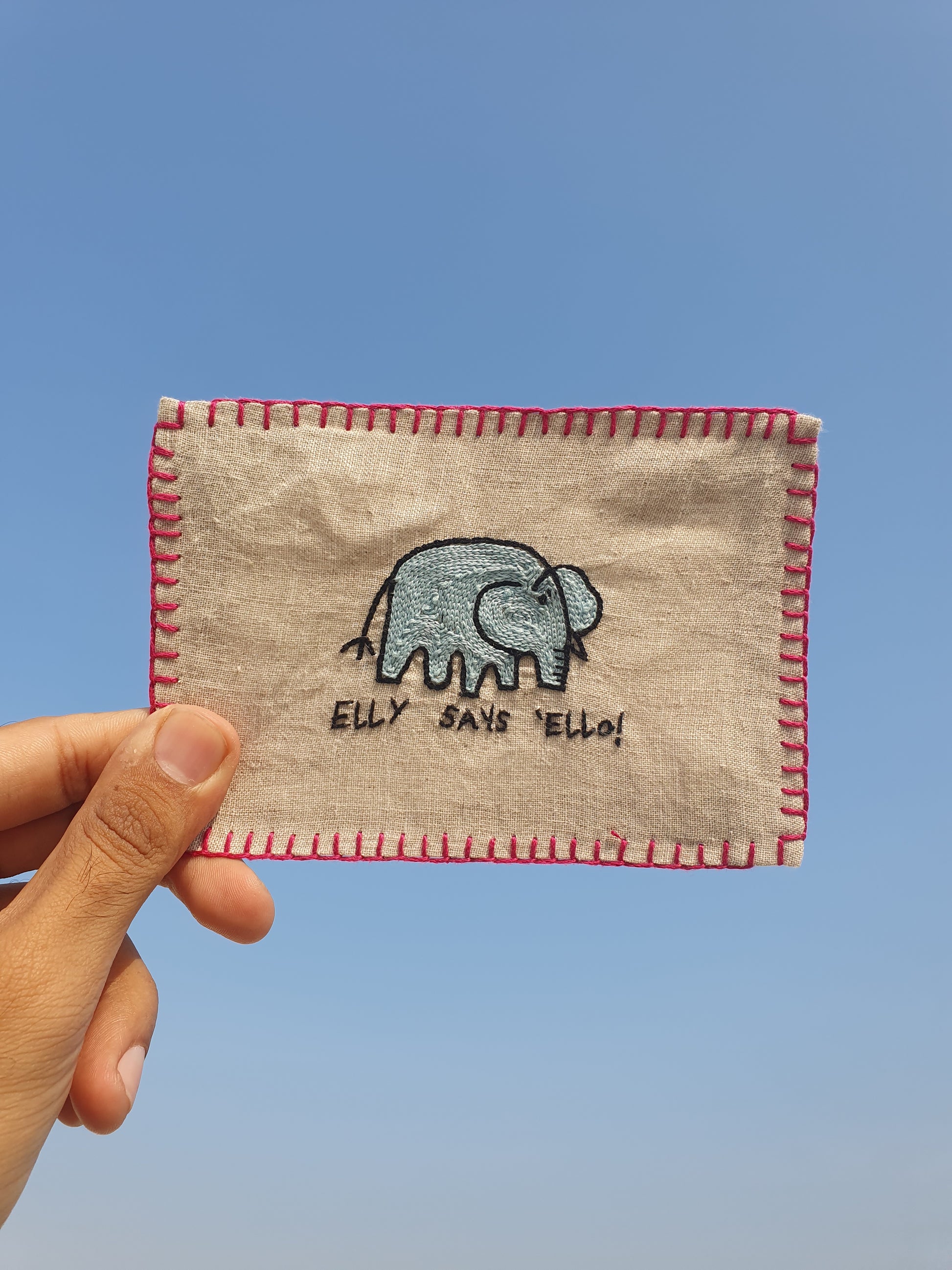 Hand-embroidered postcard featuring Elly the Elephant, who is ready to send a 'Hello' from your side