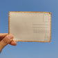 Back side of the hand-embroidered postcard showing the 225 gsm textured paper, ideal for writing with a ball pen