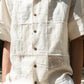 Details of an off-white half-sleeved shirt made with patches of cotton and linen squares