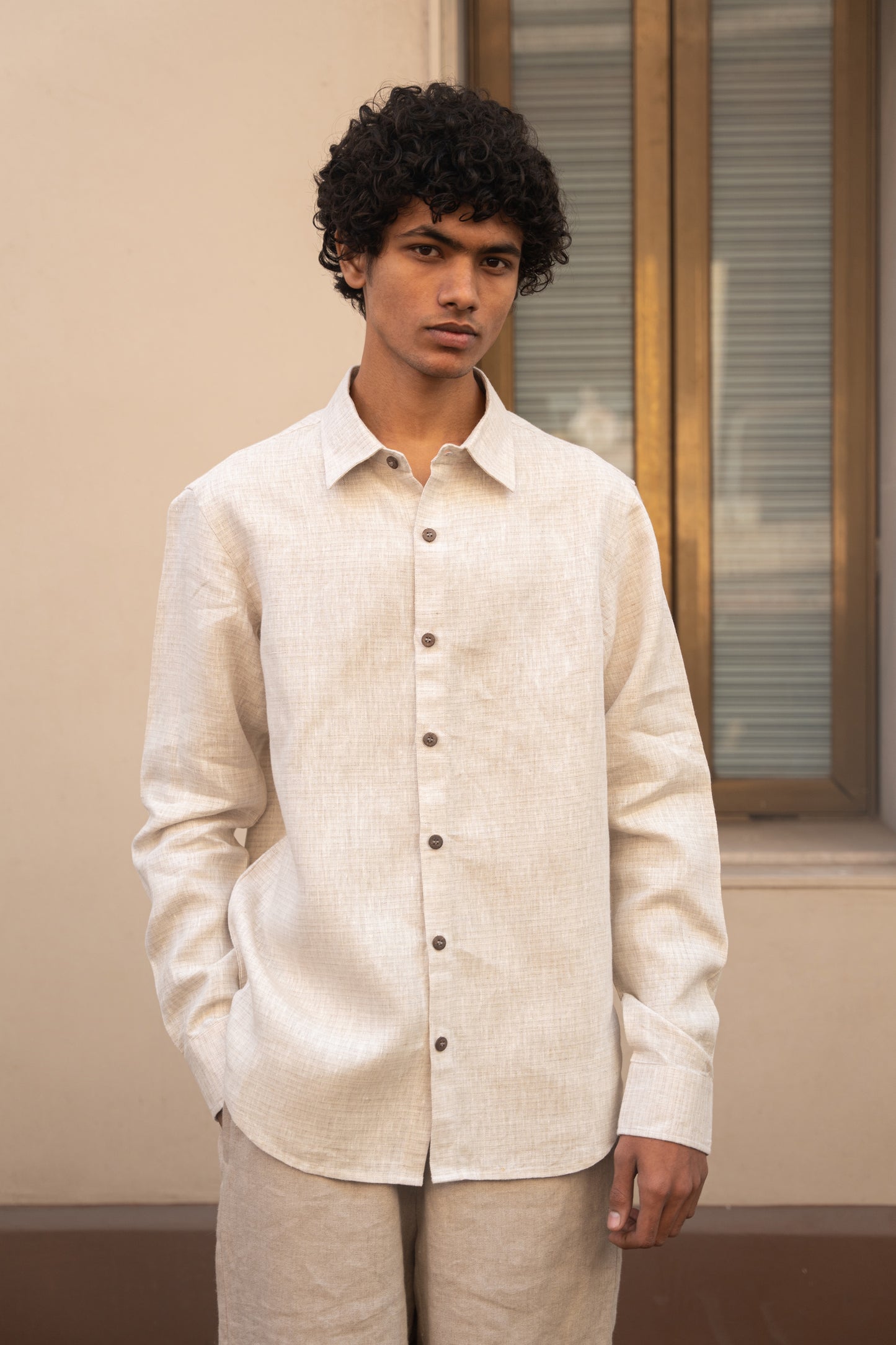 A closer look of the man in light beige full sleeved pure linen shirt 