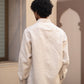 Details of the back of a man in light beige full sleeved pure linen shirt