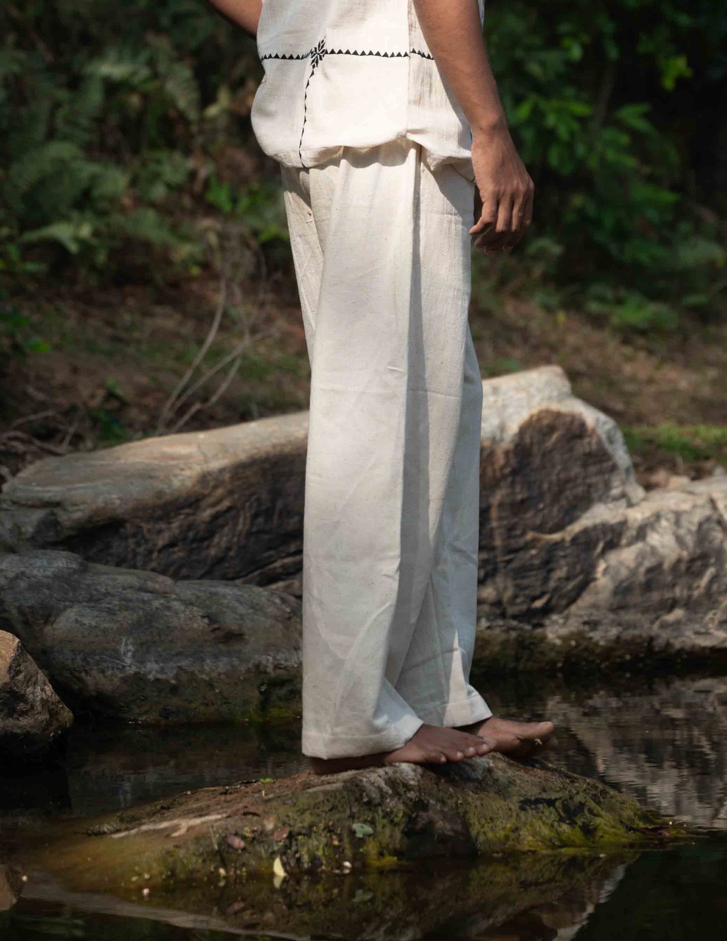 Side view of a man wearing kala cotton hand-woven lounge pants