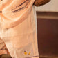 Detailed front view of peach linen shorts with hand-embroidered bananas.