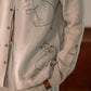 A detailed left view of a man in eco-friendly, Cats hand-embroidered linen shirt. Full sleeve shirt, Material: linen.