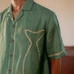 Details of the fish outline in the classy kantha style on a green linen half-sleeved shirt