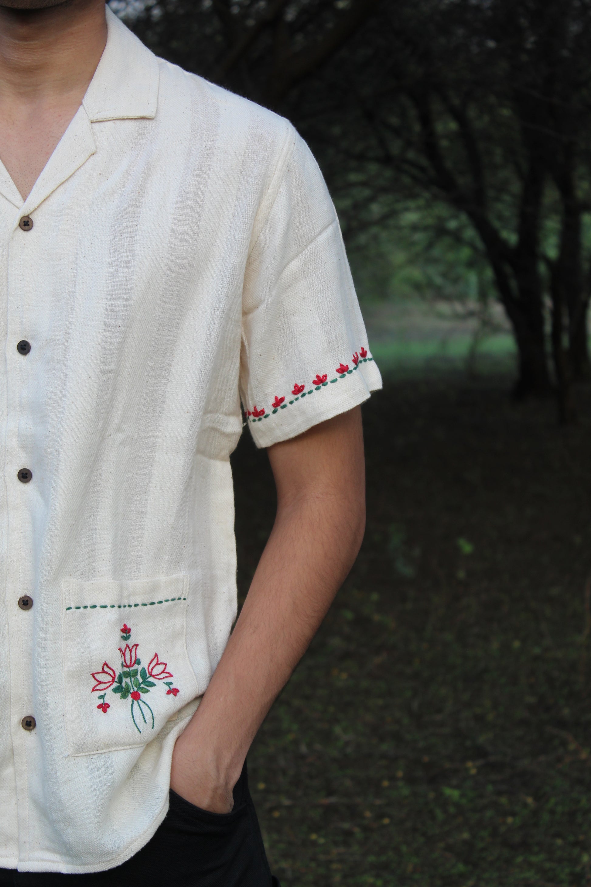 Details of a hand-woven cotton shirt with hand-embroidered pockets and sleeves