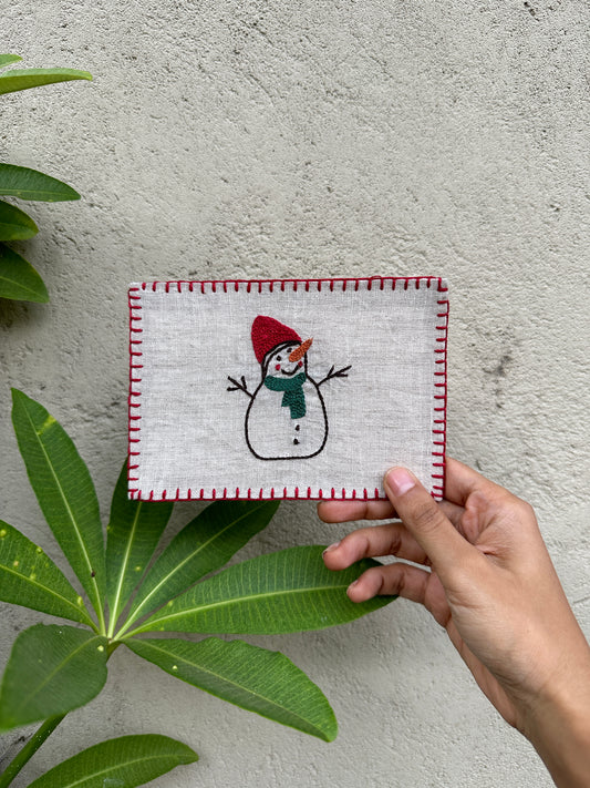 Hand-embroidered postcard featuring a festive snowman design, crafted from sustainable linen, perfect for holiday greetings