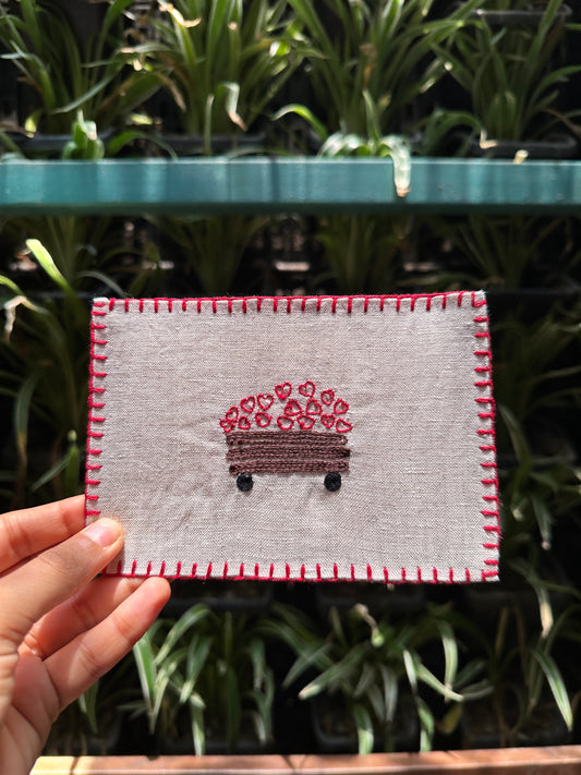 Close-up view of the hand-stitched lorry and hearts, illustrating the detailed craftsmanship and cheerful design