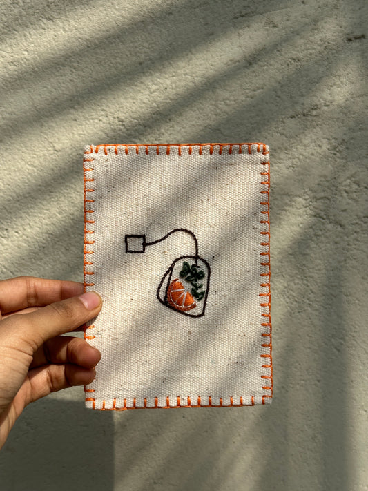 Hand-embroidered postcard featuring a vibrant design of orange slices and basil leaves on sustainable linen