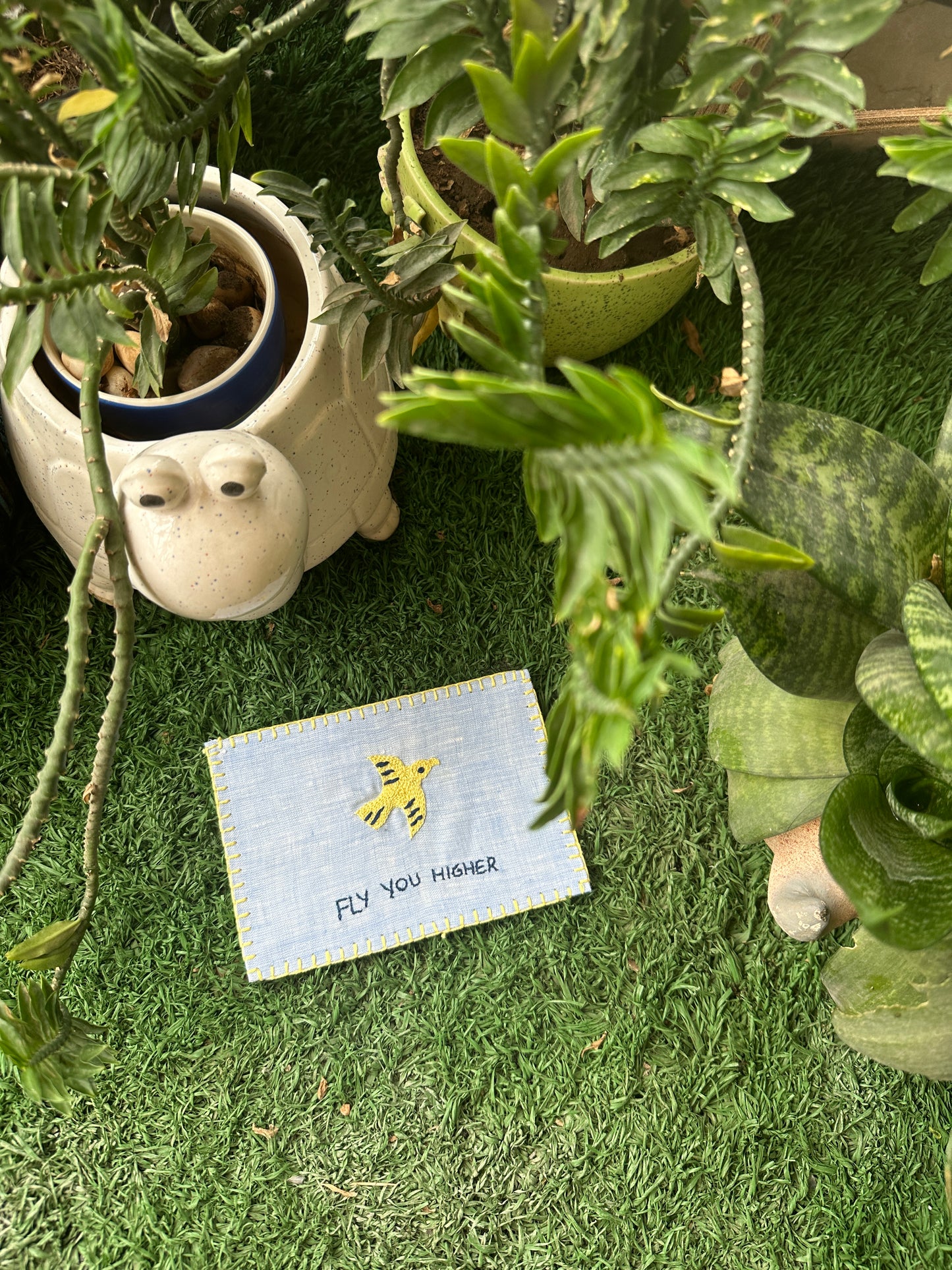 Hand-embroidered postcard featuring a soaring bird and the phrase 'Fly You Higher,' crafted from sustainable linen, ideal for inspiring greatness