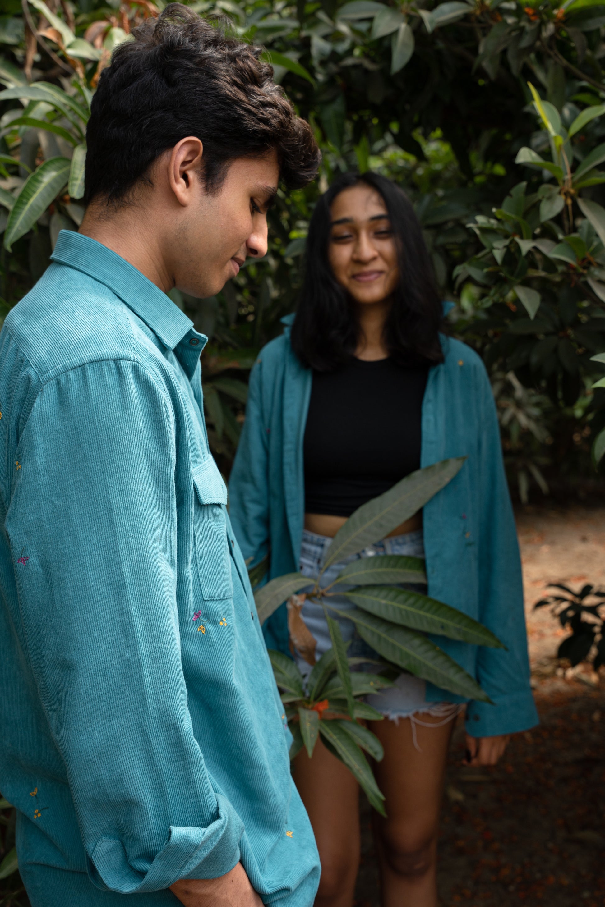 Side profile of Soham in teal cotton corduroy teal overshirt