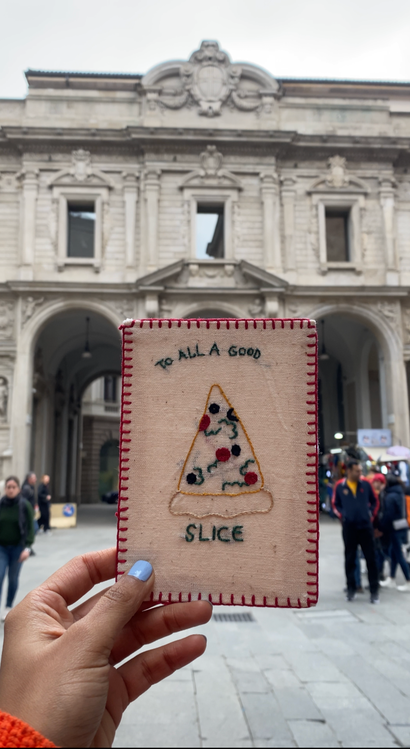 Hand-embroidered postcard featuring a colorful pizza slice on sustainable linen, ideal for food lovers and quirky art collectors