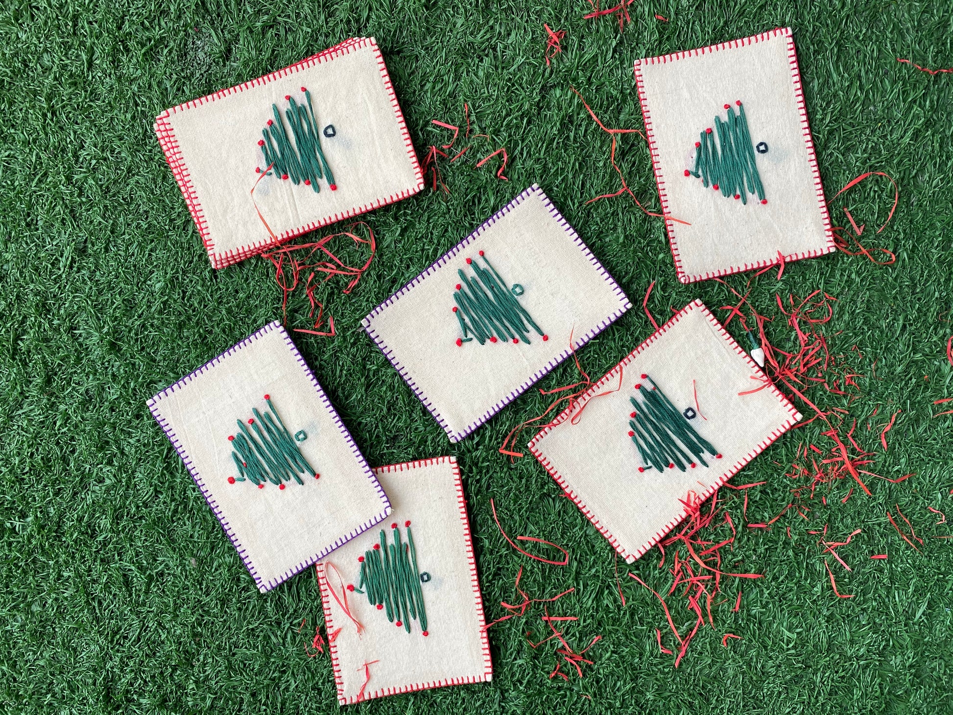 Hand-embroidered Christmas tree design on a sustainable linen postcard, ideal for festive greetings