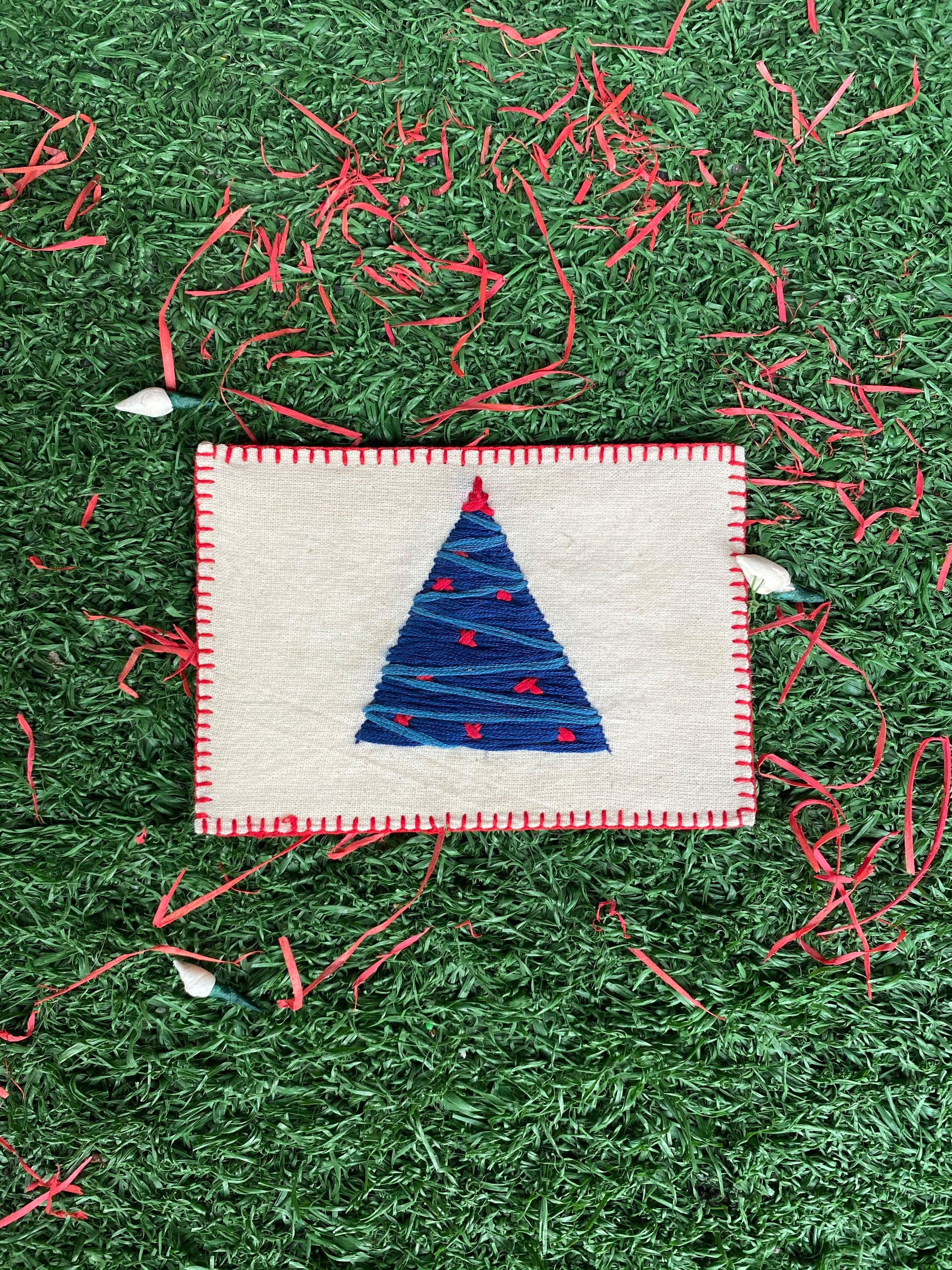 Hand-embroidered Christmas tree design on a sustainable linen postcard, ideal for festive greetings