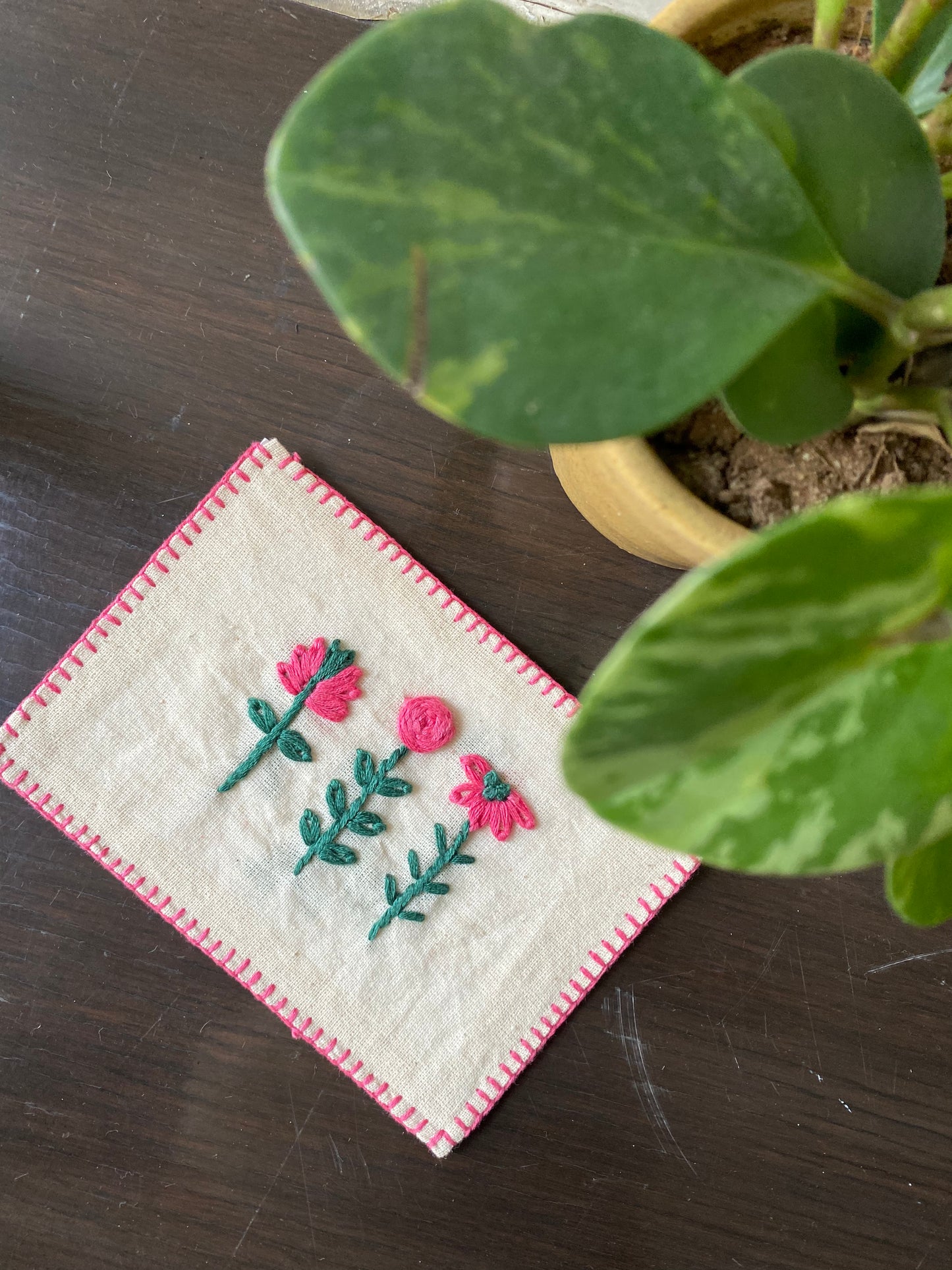 Hand-embroidered postcard featuring three distinct flowers, each with intricate stitching on sustainable linen, symbolizing natural beauty and tranquility